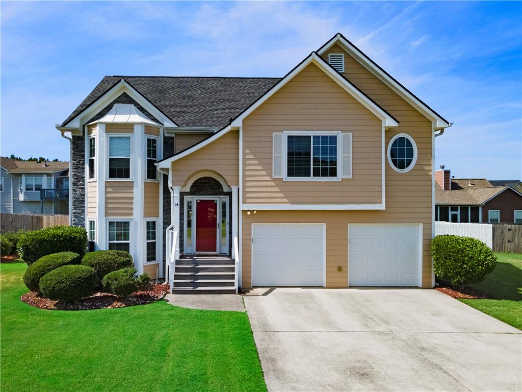 14 Independence Way Northeast Cartersville, GA 30121 - Photo 1 of 1 a front view of a house with a yard and garage