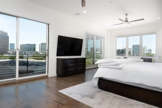a bedroom with a bed and a flat screen television