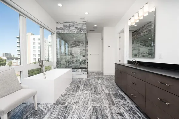 a spacious bathroom with a large mirror vanity and a shower