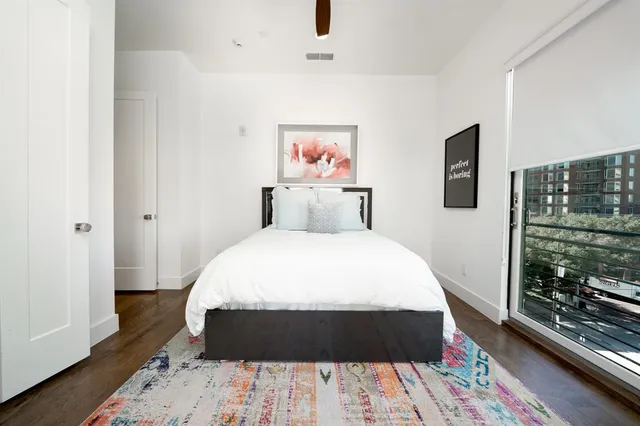 a bed sitting in a bedroom next to a window