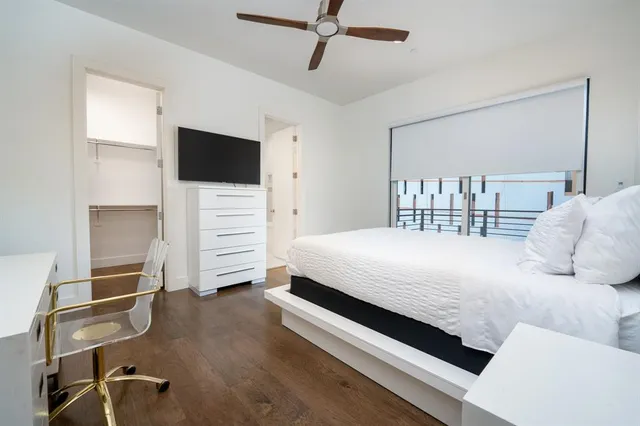 a bedroom with a bed and a television