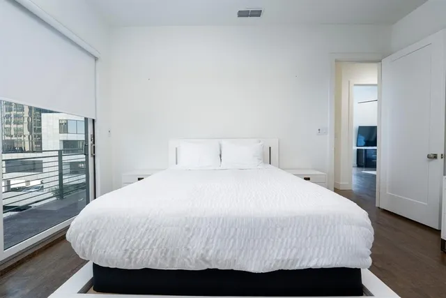 a bedroom with a bed and with view of kitchen