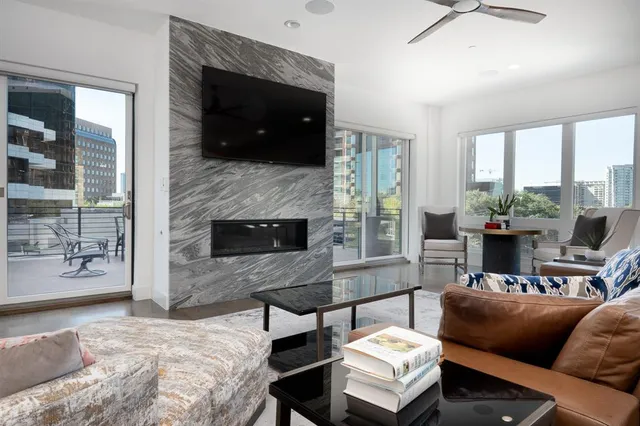 a living room with furniture and a fireplace