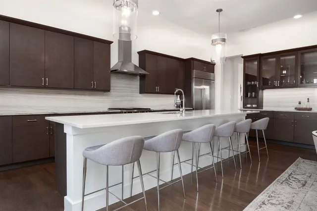 a living room with stainless steel appliances kitchen island granite countertop furniture and a kitchen view