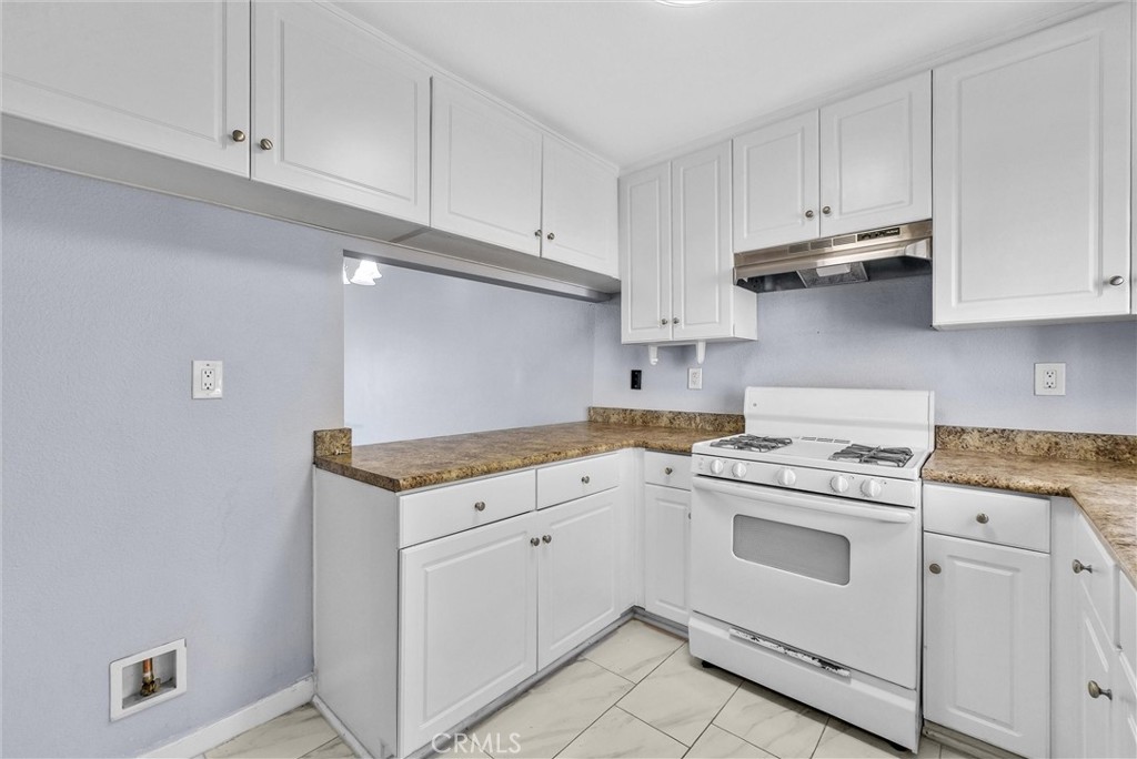 3738 Harrison Street, Unit 31 Riverside, CA 92503 - Photo 13 of 35 a kitchen with granite countertop white cabinets and white appliances