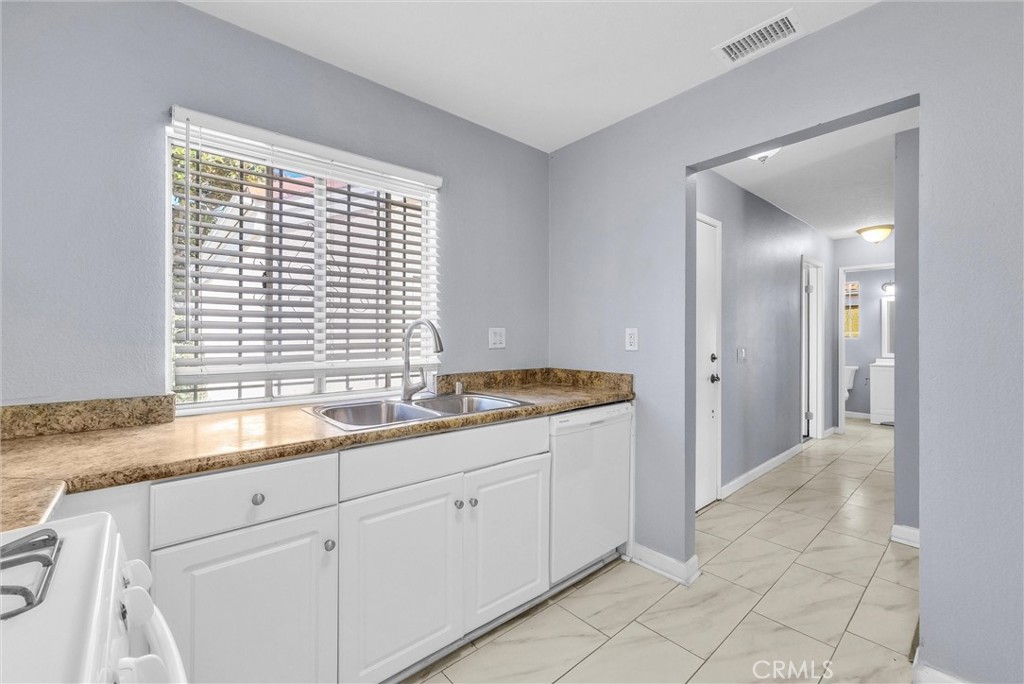 3738 Harrison Street, Unit 31 Riverside, CA 92503 - Photo 14 of 35 a bathroom with a granite countertop sink and a window