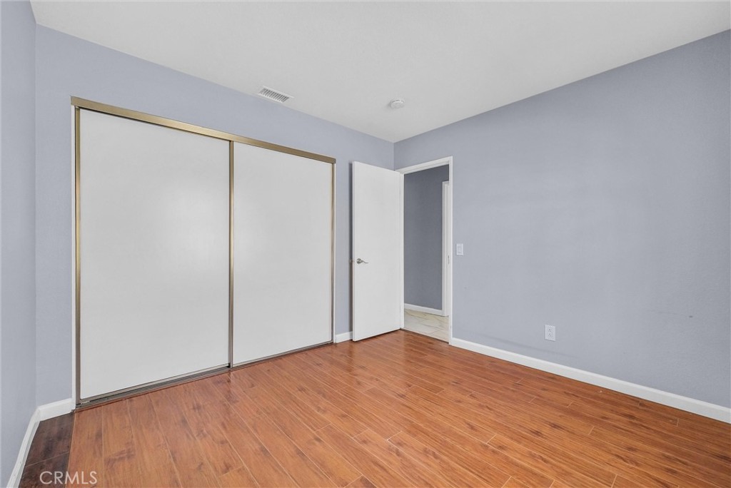 3738 Harrison Street, Unit 31 Riverside, CA 92503 - Photo 17 of 35 a view of empty room with wooden floor