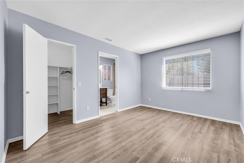 3738 Harrison Street, Unit 31 Riverside, CA 92503 - Photo 22 of 35 a view of an empty room with wooden floor and a window