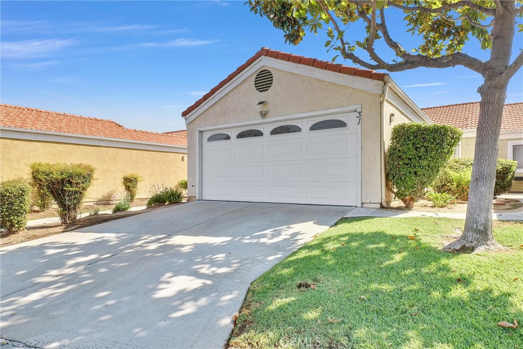 3738 Harrison Street, Unit 31 Riverside, CA 92503 - Photo 4 of 35 a front view of a house with a yard and garage
