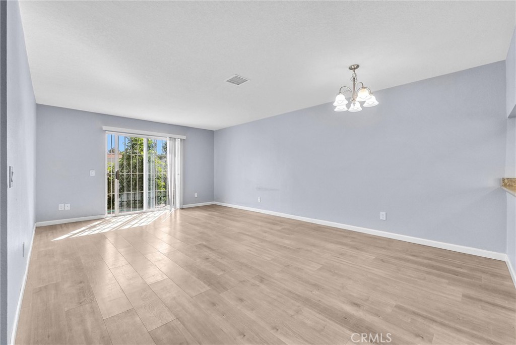 3738 Harrison Street, Unit 31 Riverside, CA 92503 - Photo 8 of 35 a view of an empty room with a window and wooden floor