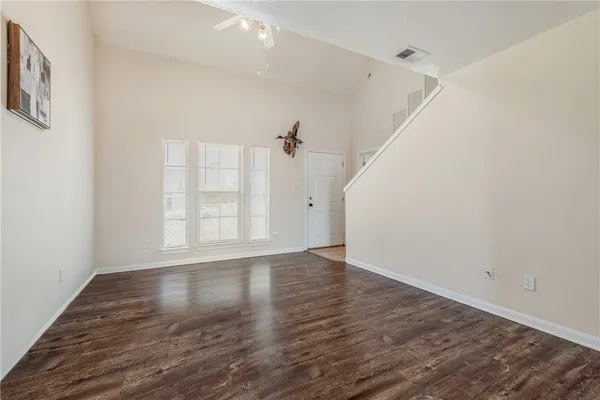 wooden floor in an empty room with a window