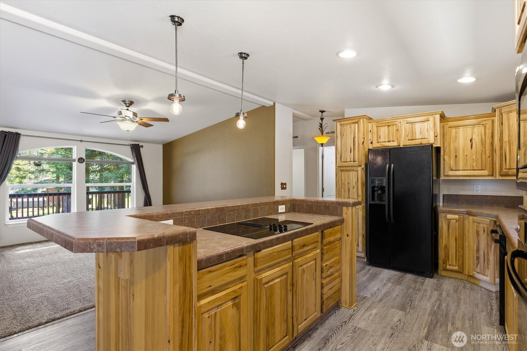 1142 Driskill Road Newport, WA 99156 - Photo 12 of 40 a kitchen that has a sink a refrigerator a stove and a wooden floor