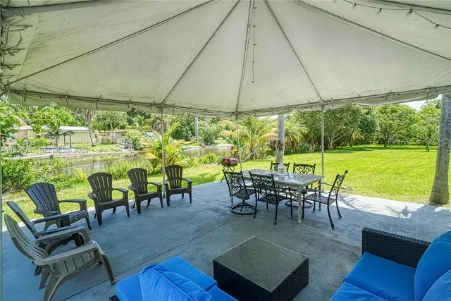 an aerial view of residential houses with outdoor space and trees
