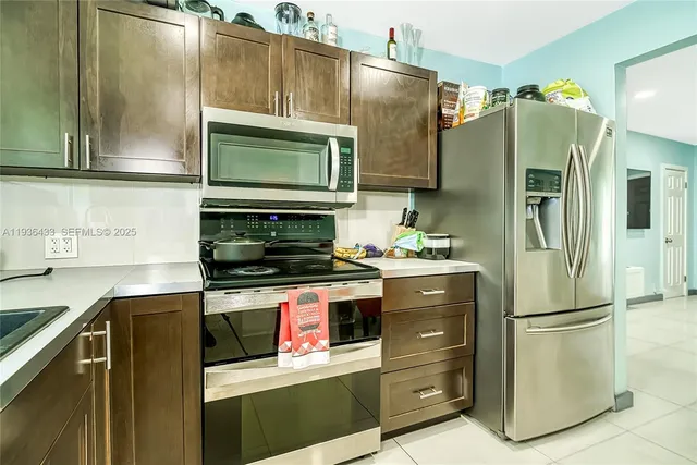 a kitchen with stainless steel appliances a stove sink and cabinets