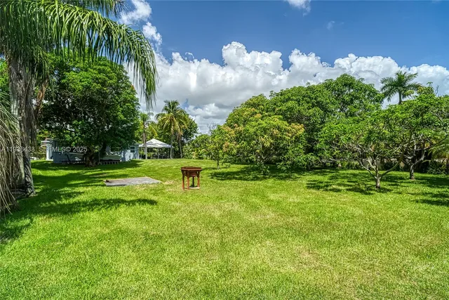 an aerial view of residential houses with city and outdoor space