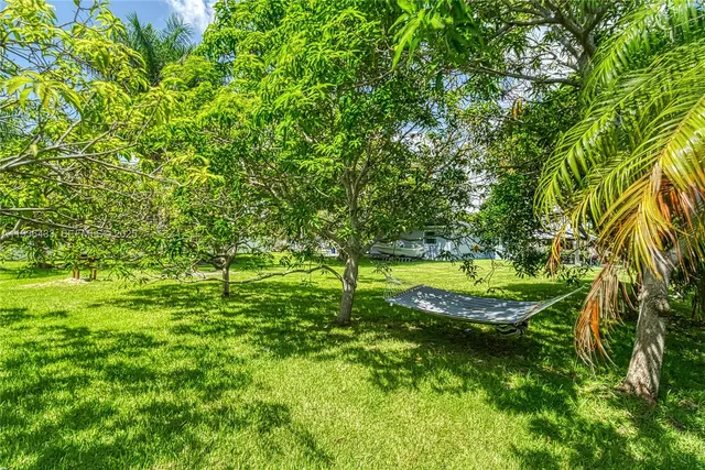 an aerial view of residential houses with outdoor space and lake view