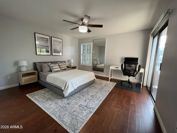 a bedroom with a large bed a chandelier and a couch