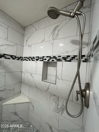 a bathroom with a shower and a mirror