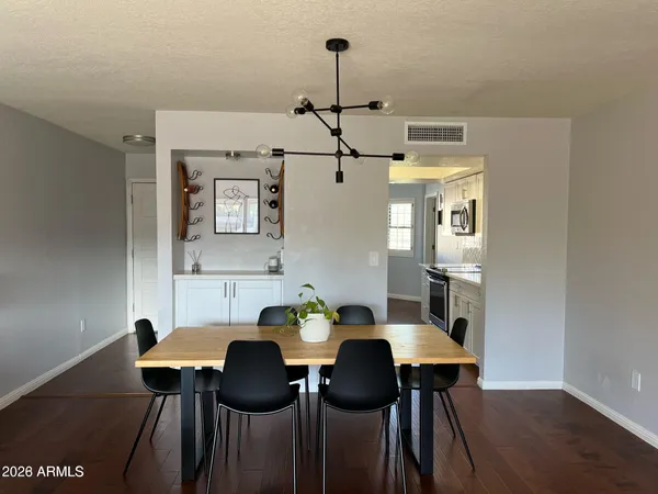 a view of a dining room with furniture and wooden floor