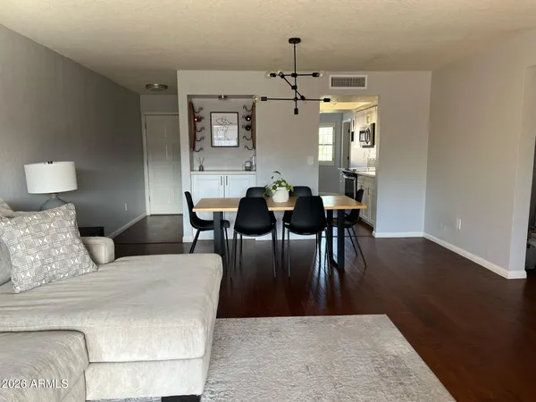 a living room with furniture and a dining table