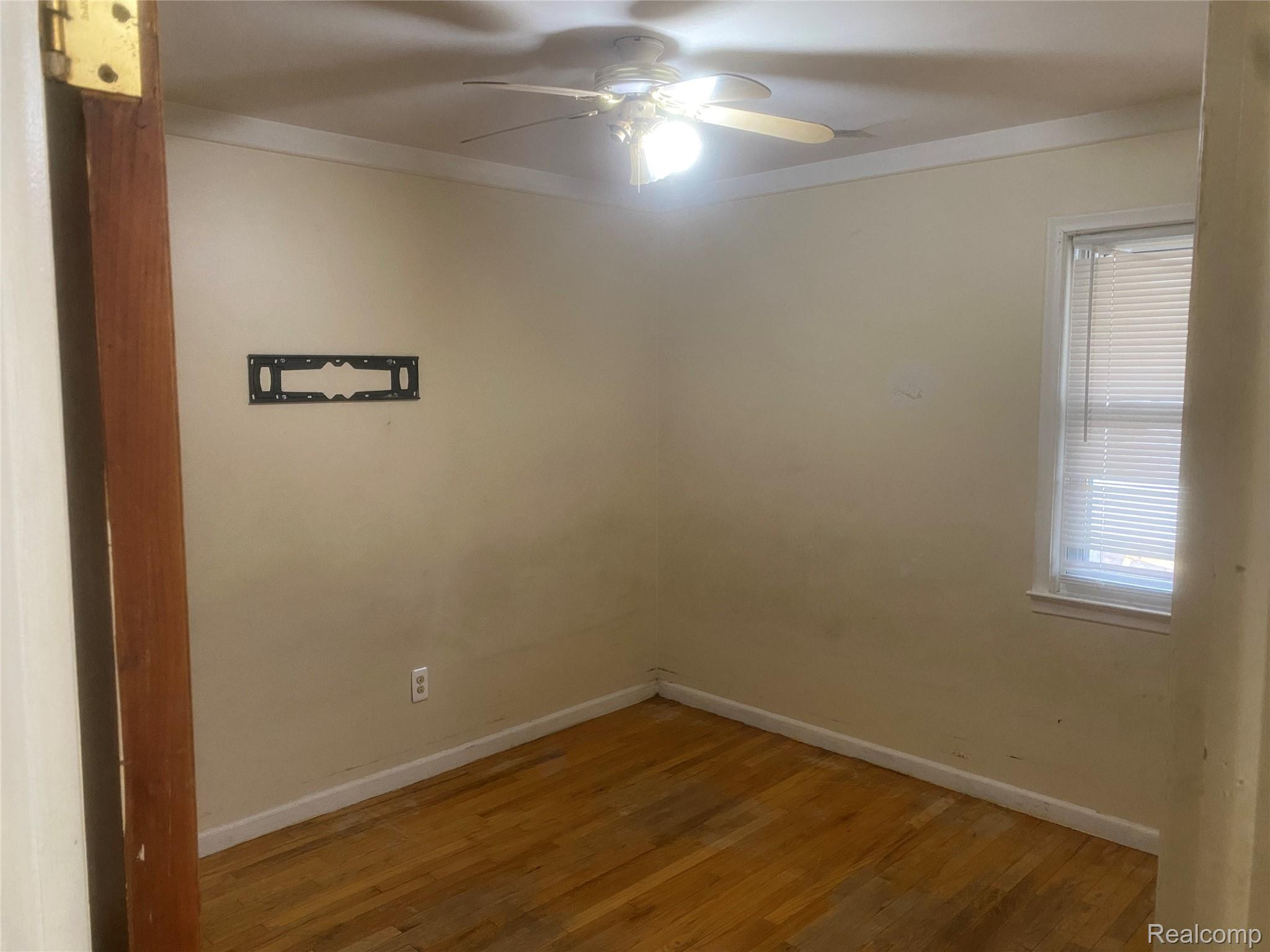 180 West Rutgers Avenue Pontiac, MI 48340 - Photo 15 of 33 Spare room featuring ornamental molding, light wood-style floors, and ceiling fan