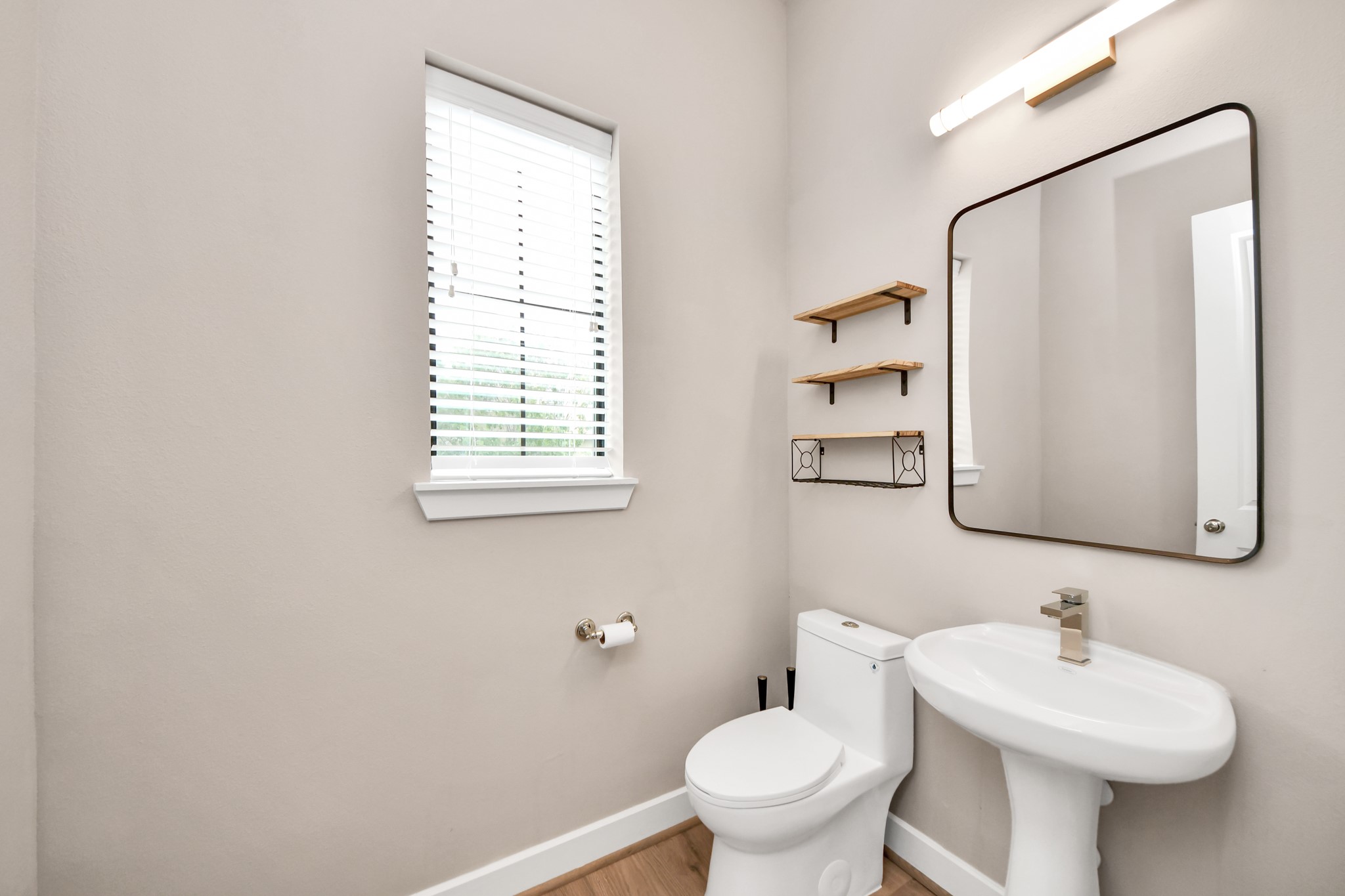 2114 Stuart Street Houston, TX 77004 - Photo 12 of 39 a bathroom with a toilet sink and mirror