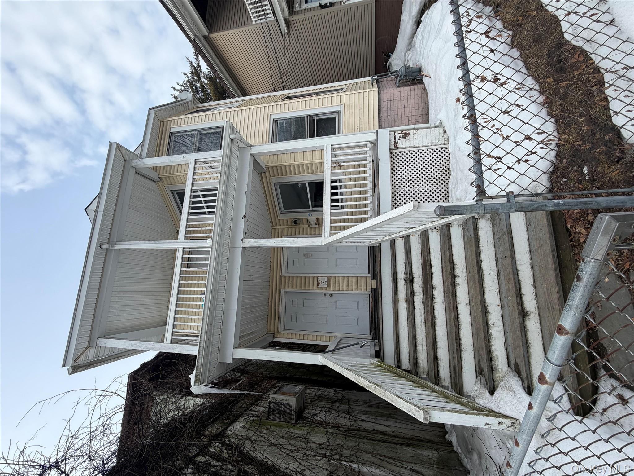 a front view of a house with stairs