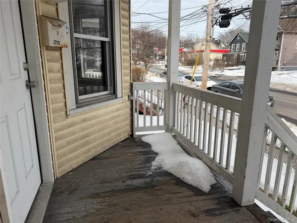 a view of a balcony with wooden floor