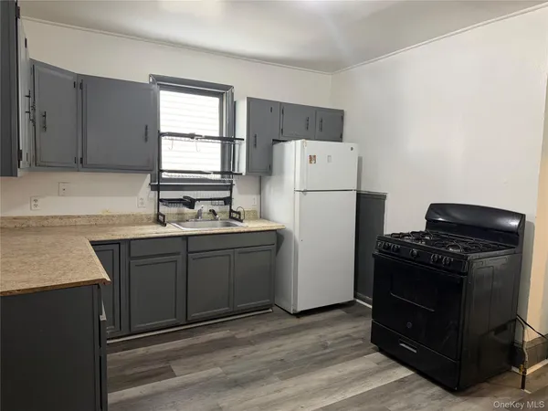 a kitchen with a refrigerator stove and sink