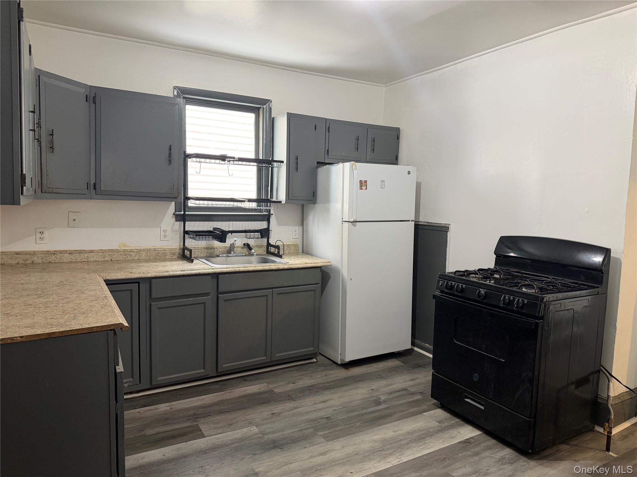 210 North Hamilton Street, Unit 1 Poughkeepsie, NY 12601 - Photo 7 of 15 a kitchen with a refrigerator stove and sink