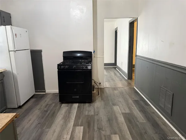 a kitchen with a refrigerator and a stove