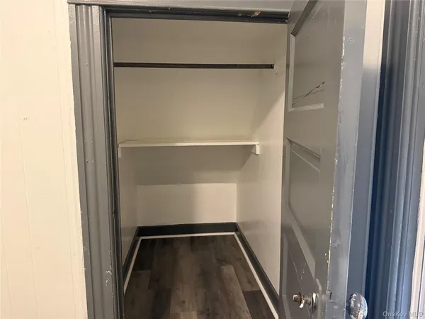 a view of walk in closet with empty racks