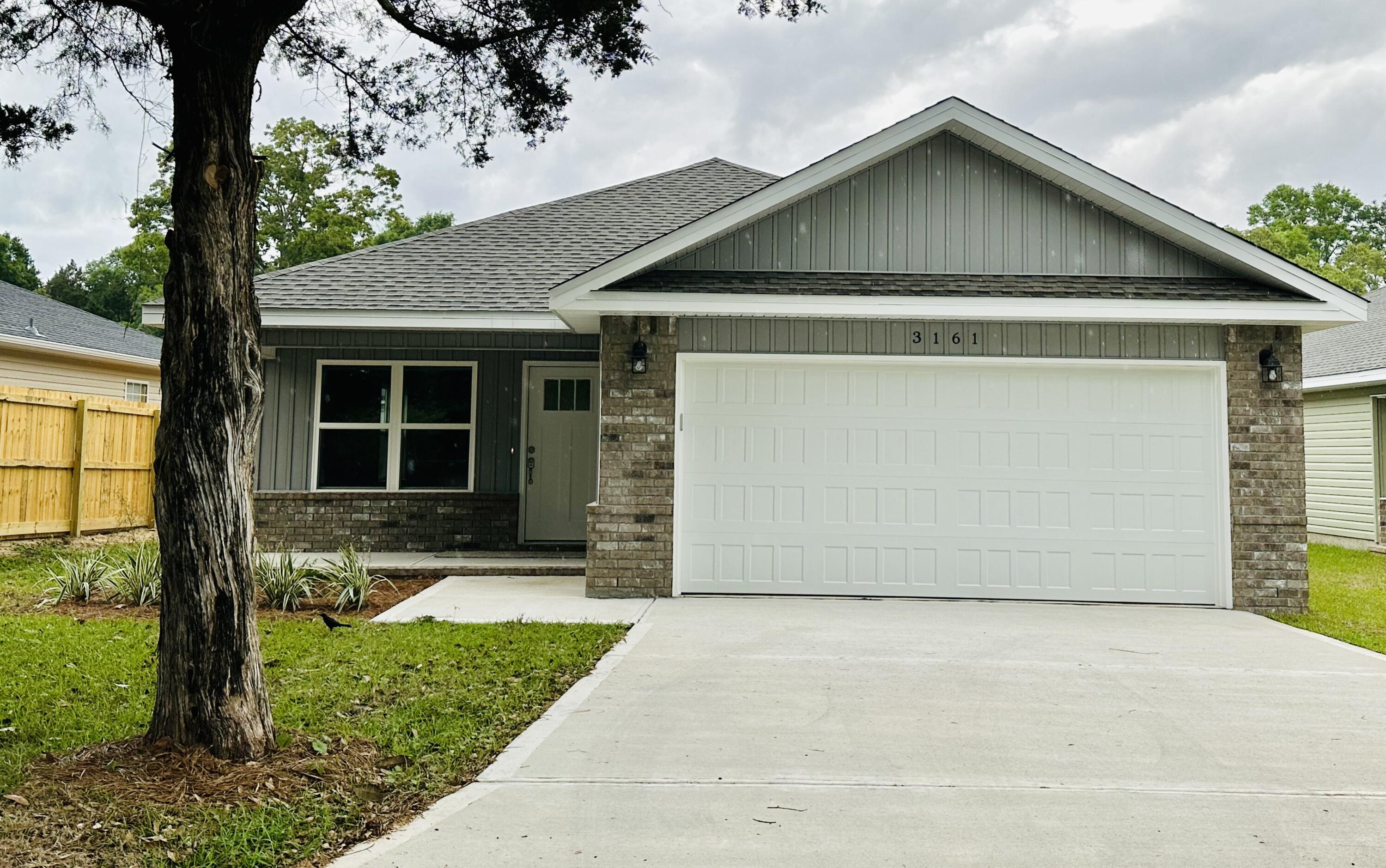 3161 Haskell Langley Road Crestview, FL 32539 - Photo 1 of 1 a front view of a house with a yard and garage