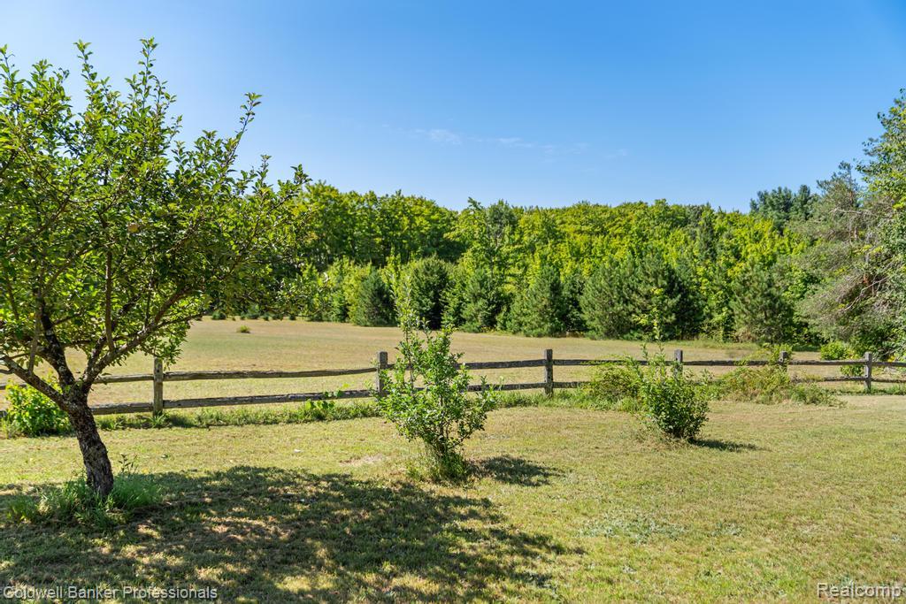 6389 Postlewait Road Mancelona, MI 49659 - Photo 50 of 50 Expansive grassy area with a rustic wood fence