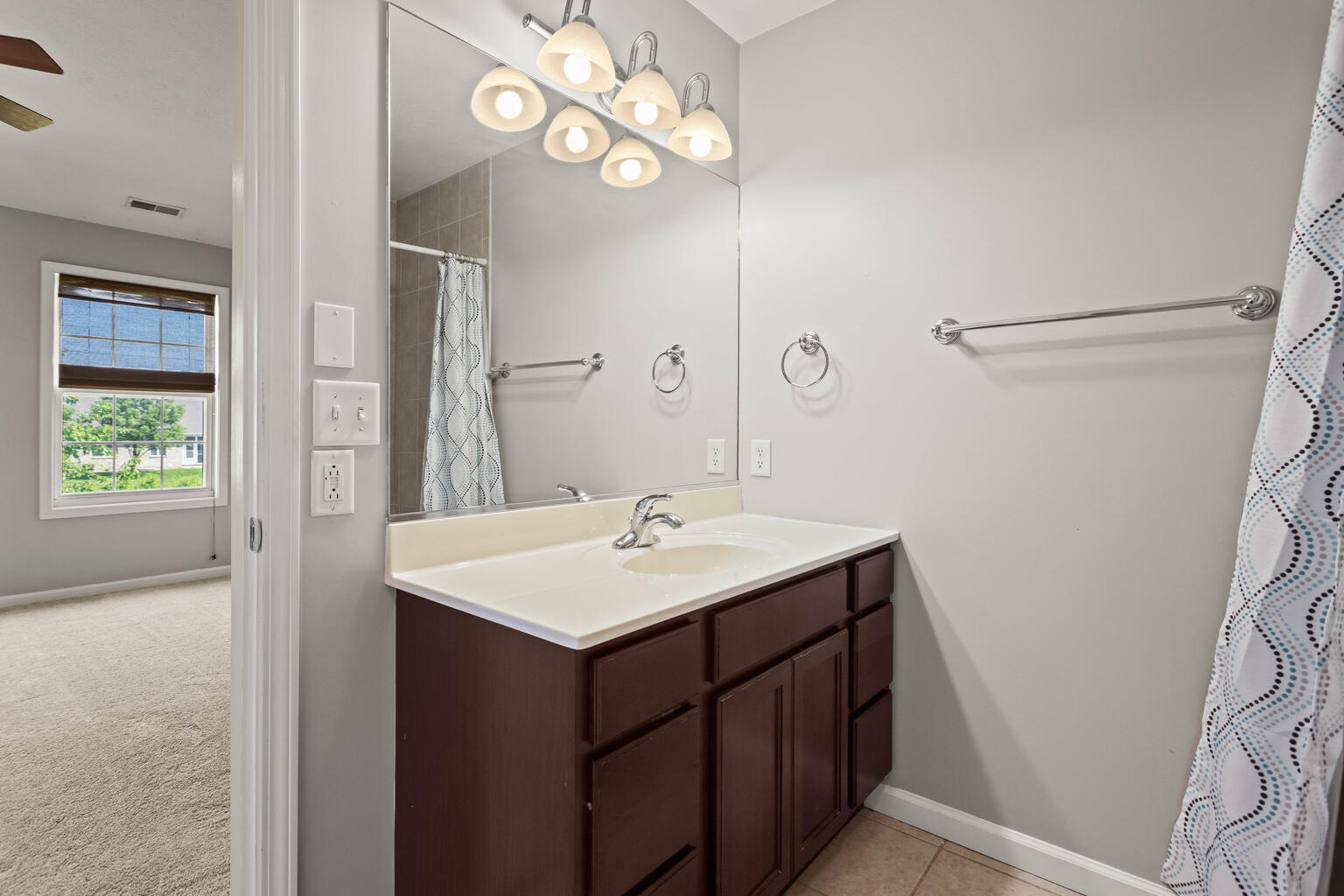 4620 Copper Ridge Road Champaign, IL 61822 - Photo 23 of 37 a bathroom with a sink a mirror and a light fixture