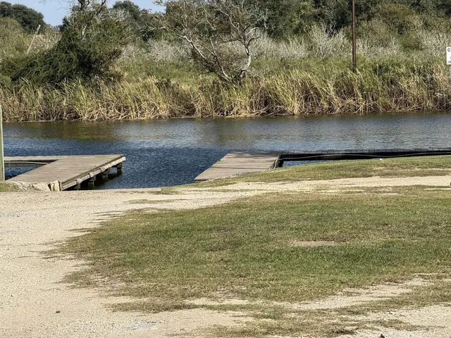 a view of a water pond with green yard
