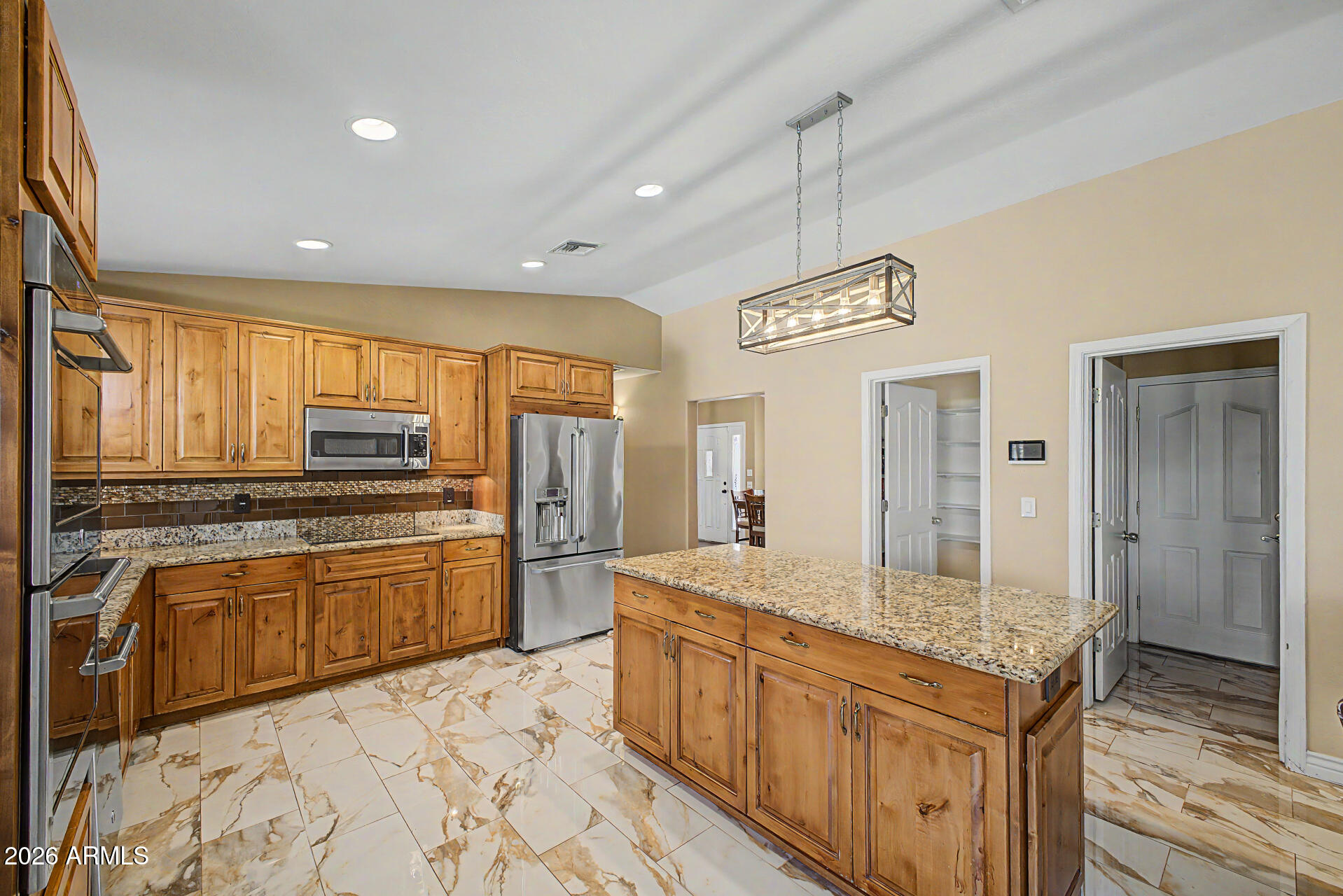 802 East Roberts Road Phoenix, AZ 85022 - Photo 9 of 24 a kitchen with stainless steel appliances granite countertop a sink stove and refrigerator
