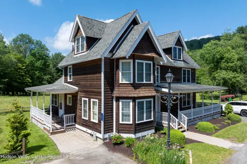 a bedroom with a bed a chair and dresser