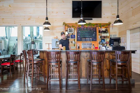 a front view of a house with a yard and outdoor seating
