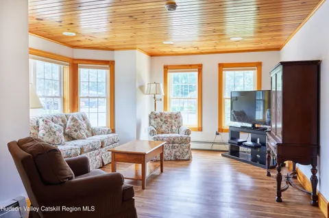 a view of a river and yard with large trees