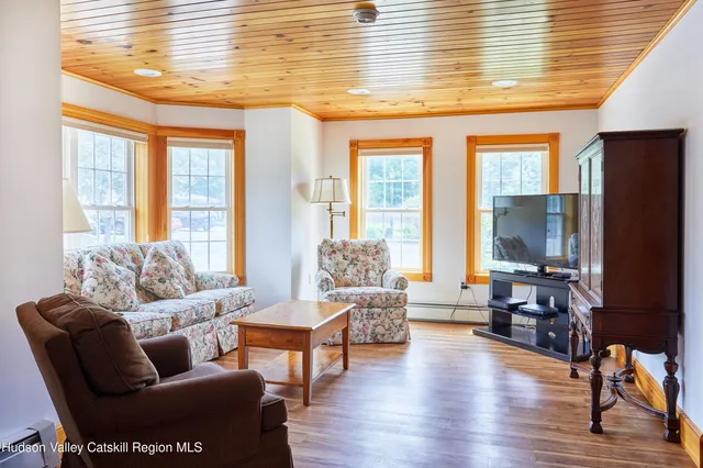 a view of a river and yard with large trees