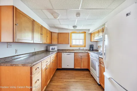 an aerial view of a house with a yard and lake view
