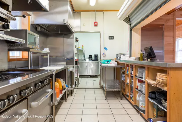 an aerial view of residential house with outdoor space and trees all around