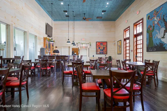 a aerial view of a house with a yard and table and chairs