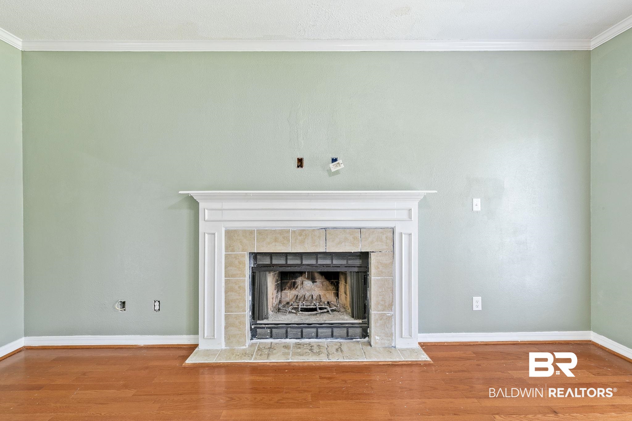 474 Ridgewood Drive Daphne, AL 36526 - Photo 16 of 57 Details featuring hardwood / wood-style floors, crown molding, and a tiled fireplace