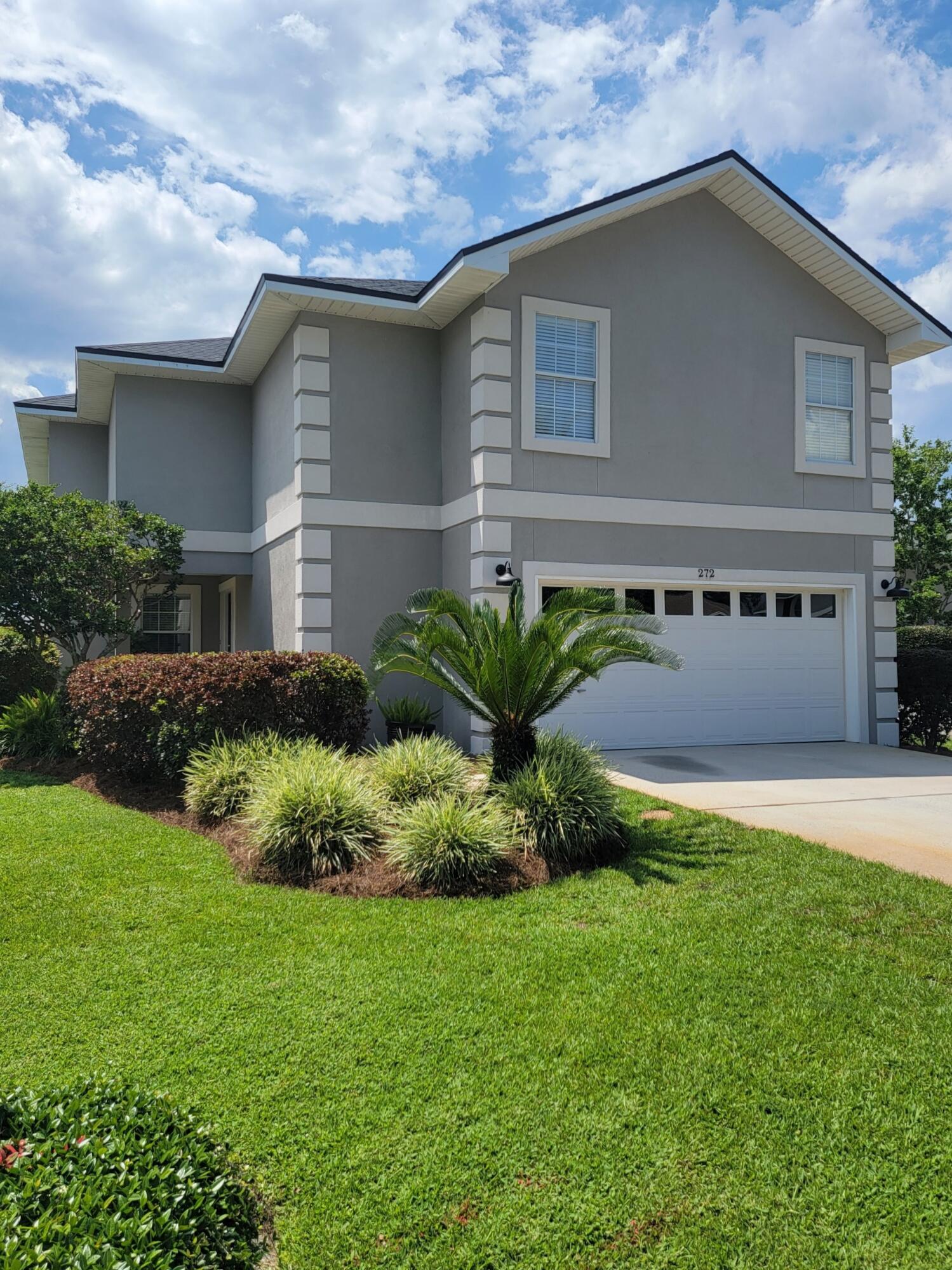 272 Chipola Cove Destin, FL 32541 - Photo 1 of 1 a front view of a house with a yard and garage