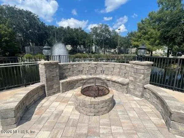 a view of a swimming pool with a patio and fire pit
