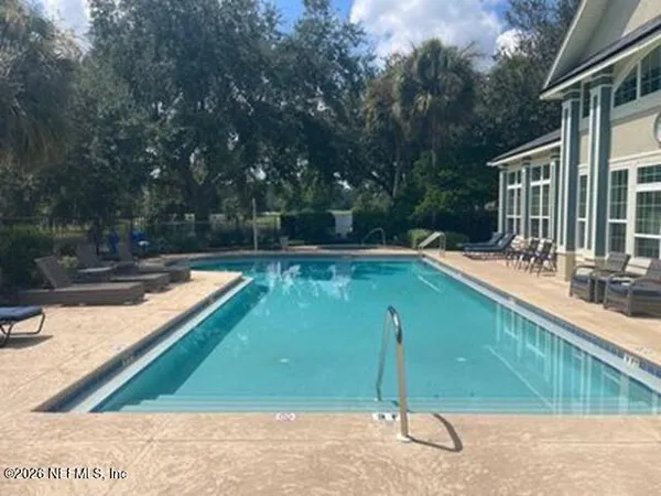 a view of a swimming pool with a patio