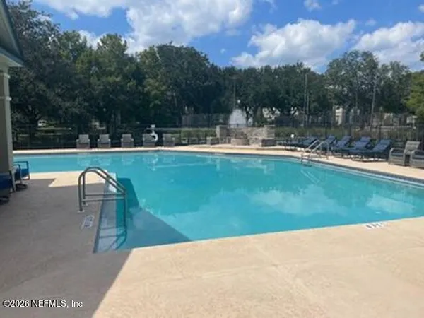 a view of a swimming pool and a yard