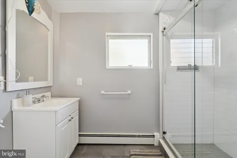 a bathroom with a sink and mirror